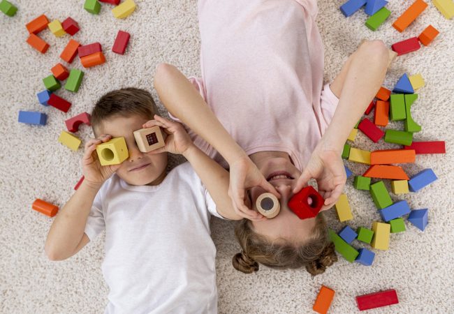 top-view-non-binary-kids-playing-with-colorful-game